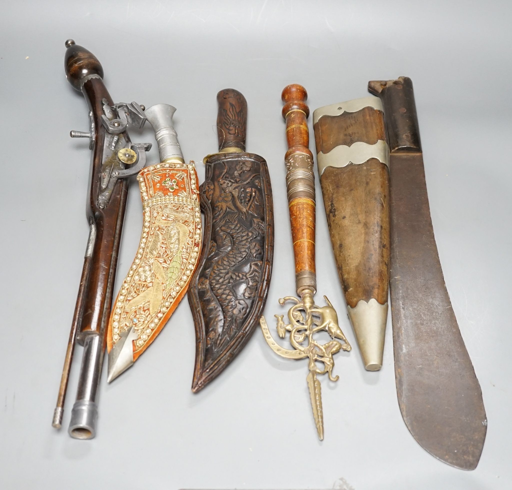 A replica flintlock pistol, machete, etc.